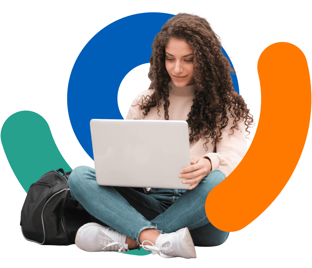 Smiling student in earphones watching laptop at table at home